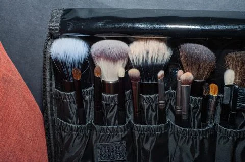 Makeup brushes on a black background, with a place to insert text, Stock Photos