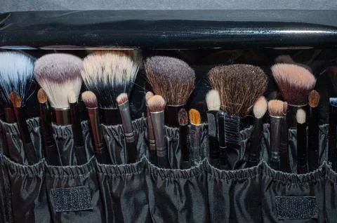 Makeup brushes on a black background, with a place to insert text, Stock-Fotos