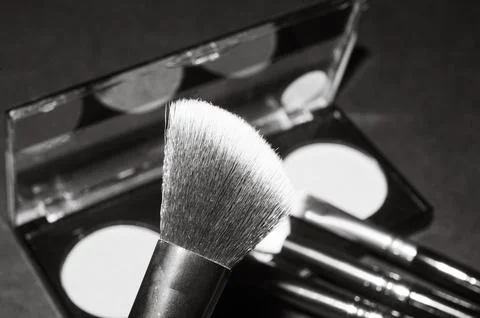 Makeup brushes on a black background, with a place to insert text, Stock Photos