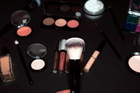Makeup brushes on a black background, with a place to insert text, Stock Photos