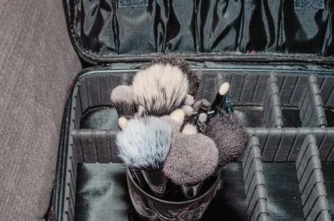 Makeup brushes on a black background, with a place to insert text, Stock Photos
