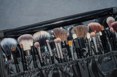 Makeup brushes on a black background, with a place to insert text, Stock Photos