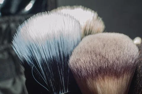 Makeup brushes on a black background, with a place to insert text, Stock Photos