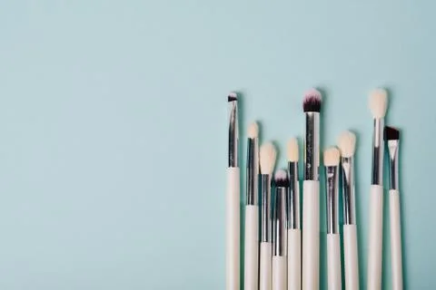 Makeup brushes on a blue background close up Stock Photos
