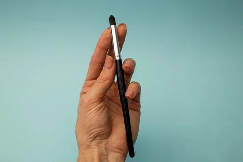 Makeup brushes on a blue background Stock Photos
