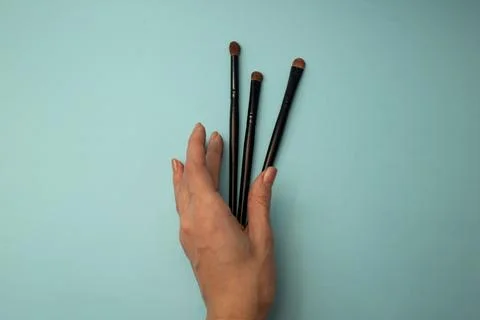 Makeup brushes on a blue background Stock Photos