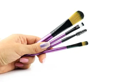 Makeup brushes for blush and eye shadow in the girl's hand Foto stock