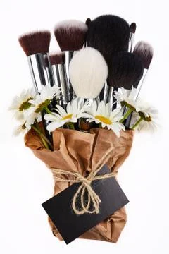 Makeup brushes with chamomiles Stock Photos