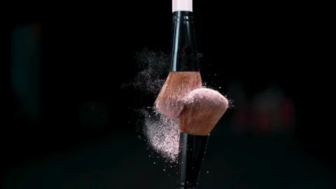 Makeup brushes colliding with exploding powder particles Stock Footage 334873619