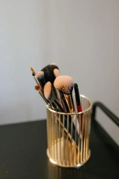 Makeup Brushes in Elegant Gold Holder on Display Stock Photos