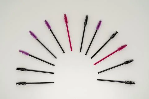Makeup brushes, eyelash combs and eyebrows on white background Stock Photos