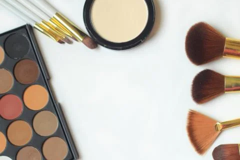 Makeup brushes, eyeshadow and powder isolated on white background Stock Photos