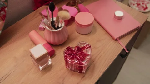 Makeup Brushes, Heart-Shaped Perfume Bottle, Pink Notebook and Beauty Products Stock-Footage 326604061