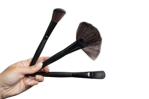 Makeup brushes held by a hand Stock Photos