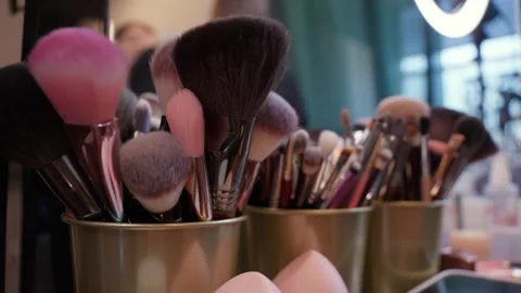 Makeup brushes in holder on professional table 스톡 동영상 320202391