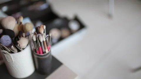 Makeup brushes in holders on a vanity table Stock Footage 336467519
