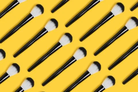Makeup brushes pattern on a yellow background. Stock Photos