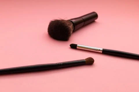Makeup brushes on a pink background. Stock Photos