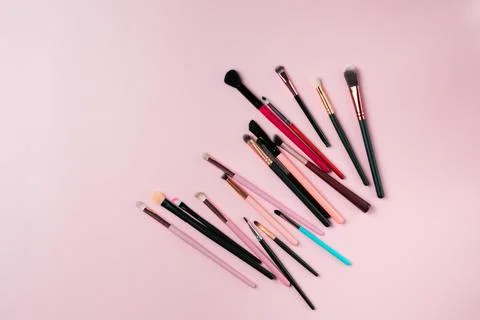 Makeup brushes on pink background. Top view point, flat lay. Stock Photos