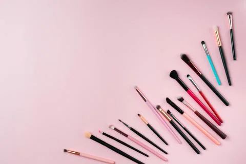 Makeup brushes on pink background. Top view point, flat lay. Stock Photos