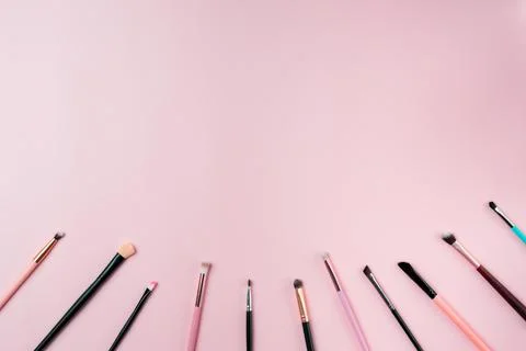 Makeup brushes on pink background. Top view point, flat lay. Stock Photos