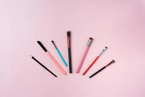 Makeup brushes on pink background. Top view point, flat lay. Stock Photos