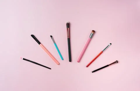 Makeup brushes on pink background. Top view point, flat lay. Stock Photos