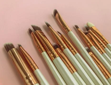 Makeup brushes on pink cute background. makeup table for the princess. beau.. Stock Photos