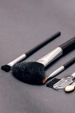 Makeup brushes on a purple background closeup Stock Photos