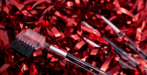 Makeup brushes on a red shiny background. Makeup tools. Stock Photos