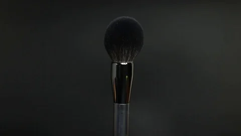 Makeup brushes rotate on a black background. Stock Footage 127614100