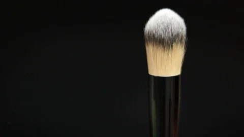 Makeup brushes rotate on a black background. Stock Footage 127614110