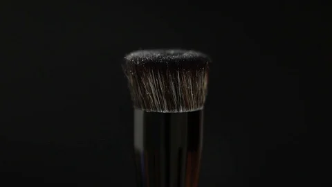 Makeup brushes rotate on a black background. Stock Footage 127614121