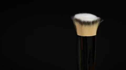 Makeup brushes rotate on a black background. Stock Footage 127614127