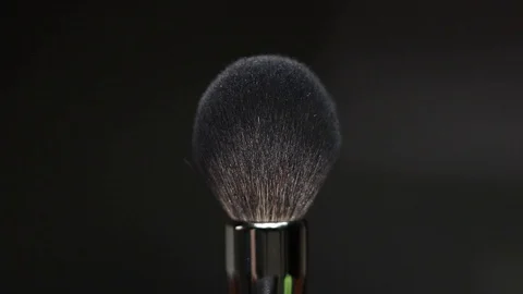Makeup brushes rotate on a black background. Stock Footage