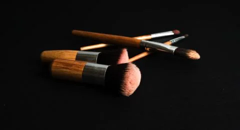 Makeup brushes set on dark background Stock Photos