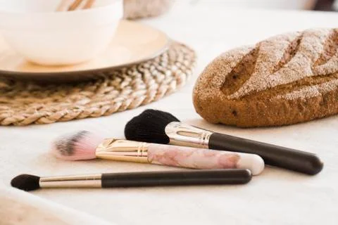 Makeup brushes on table. Light Scandinavian style kitchen Stock Photos