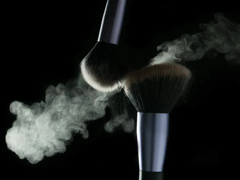 Makeup brushes' touch on black background Fotos Stock