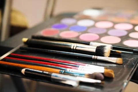 Makeup brushes, visage. Professional brushes lie on a palette with multi-colo Stock Photos