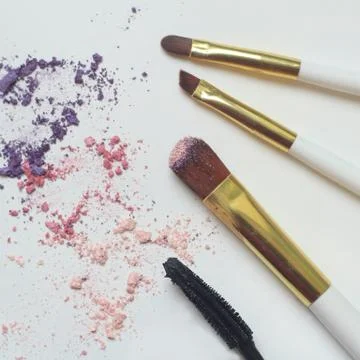 Makeup Brushes on White Background with Colorful Pigment Powder Stock Photos