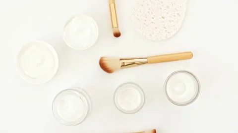 Makeup brushes. White cosmetic bottle containers. Natural skin care products Stock Footage 234699170