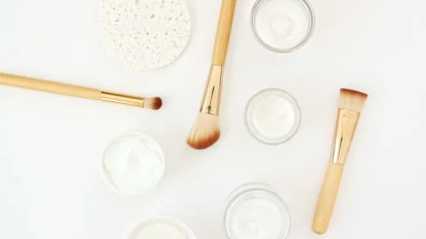 Makeup brushes. White cosmetic bottle containers. Natural skin care products Stock Footage 245842176
