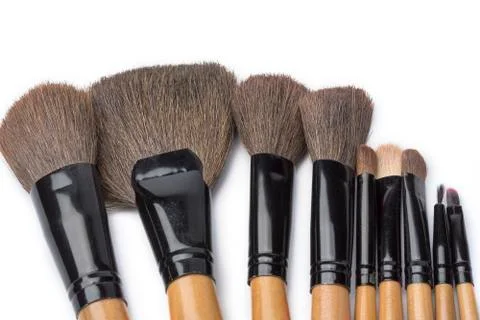 Makeup brushes on white isolated background for female beauty. Stock Photos