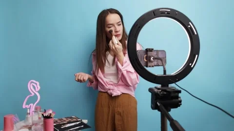 Makeup Content Creator Filming Skincare or Cosmetic Video with Flamingo Lig.. Stock Footage 308224905
