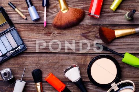 Makeup cosmetics, brushes and other on brown background Stock Photos