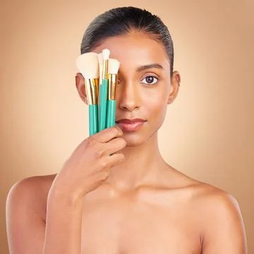 Makeup, cover and brush with portrait of Indian woman in studio for foundation Stock Photos