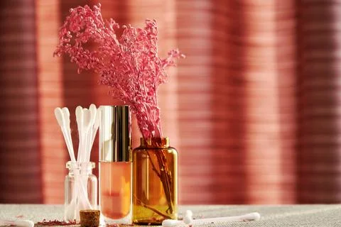 Makeup desk in the cosmetics store with jars, lipstick, gloss and cotton buds Stock Photos