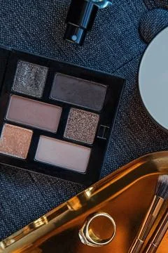 Makeup Essentials on Dark Fabric Stock Photos