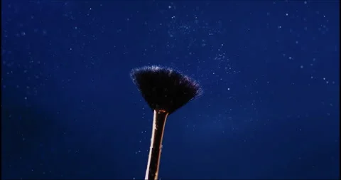 Makeup falling off a makeup brush in slow motion Stock Footage 242454928