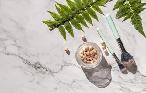 Makeup flat lay. Decorative cosmetics and makeup brushes on marble countertop Stock Photos